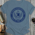 T-shirt with blue circular graphic: "Outdoor Introvert Club, First Up, First Asleep."