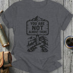 Dark grey t-shirt with "You Are Not Almost There" mountain path graphic.