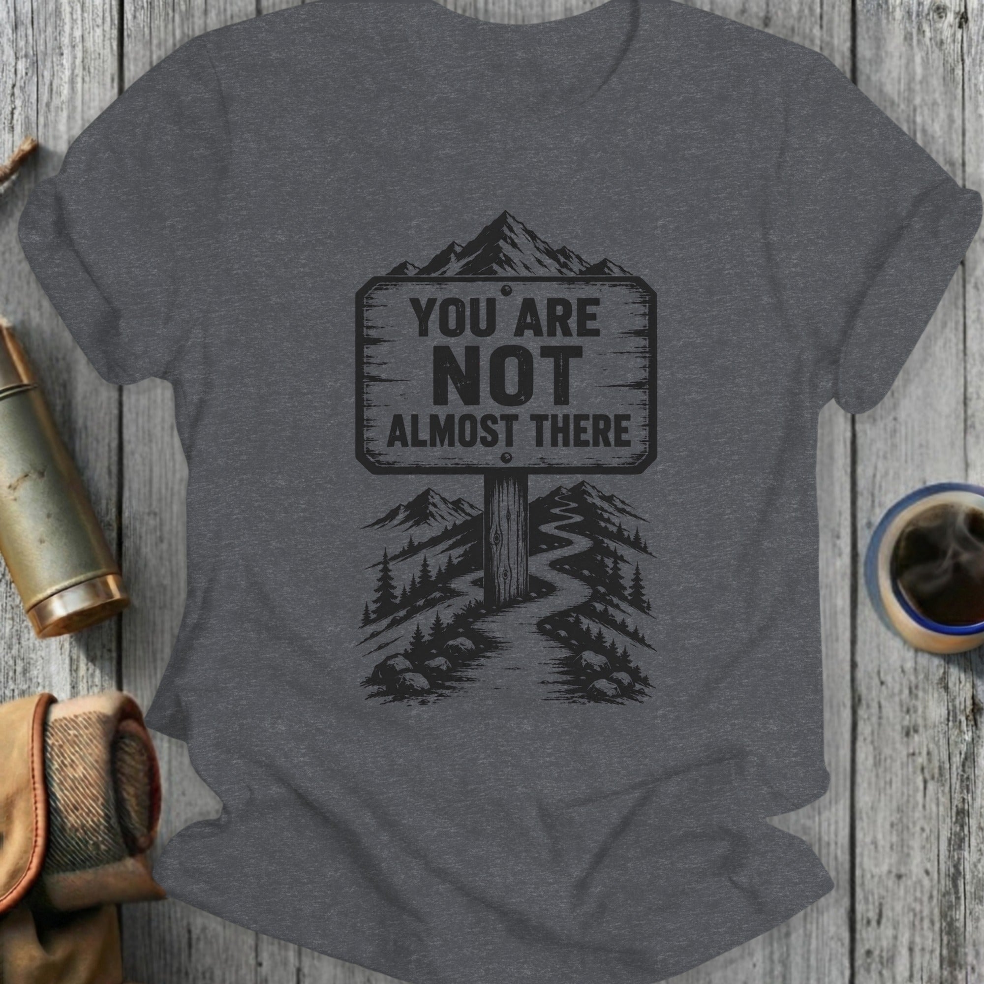 Dark grey t-shirt with "You Are Not Almost There" mountain path graphic.