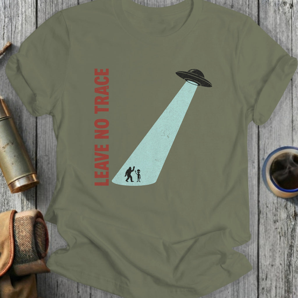 Olive green t-shirt with UFO beam abducting two small figures and "LEAVE NO TRACE" text.