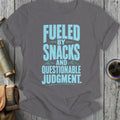 Gray t-shirt with light blue text: Fueled by snacks and questionable judgment.