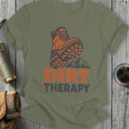 Orange hiking boot graphic with "DIRT THERAPY" text on a green t-shirt.