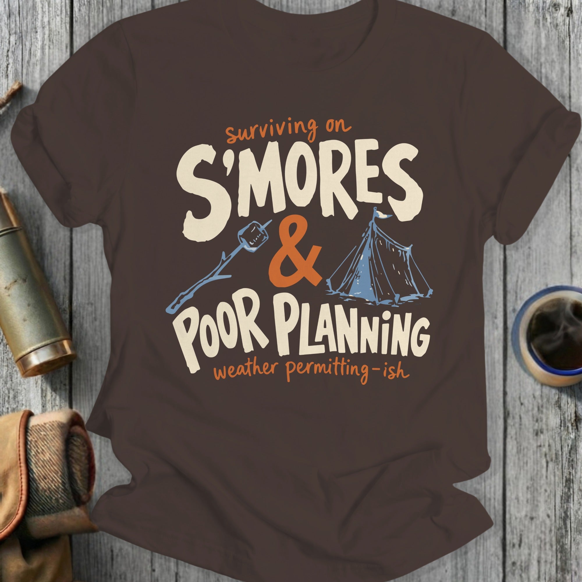 T-shirt with graphic reading "Surviving on S'mores & Poor Planning"