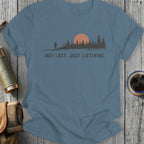 T-shirt with graphic of lone figure, pine trees, and sunset with text "NOT LOST. JUST LISTENING."