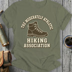 Green t-shirt with "The Moderately Athletic Hiking Association" and hiking boot graphic.