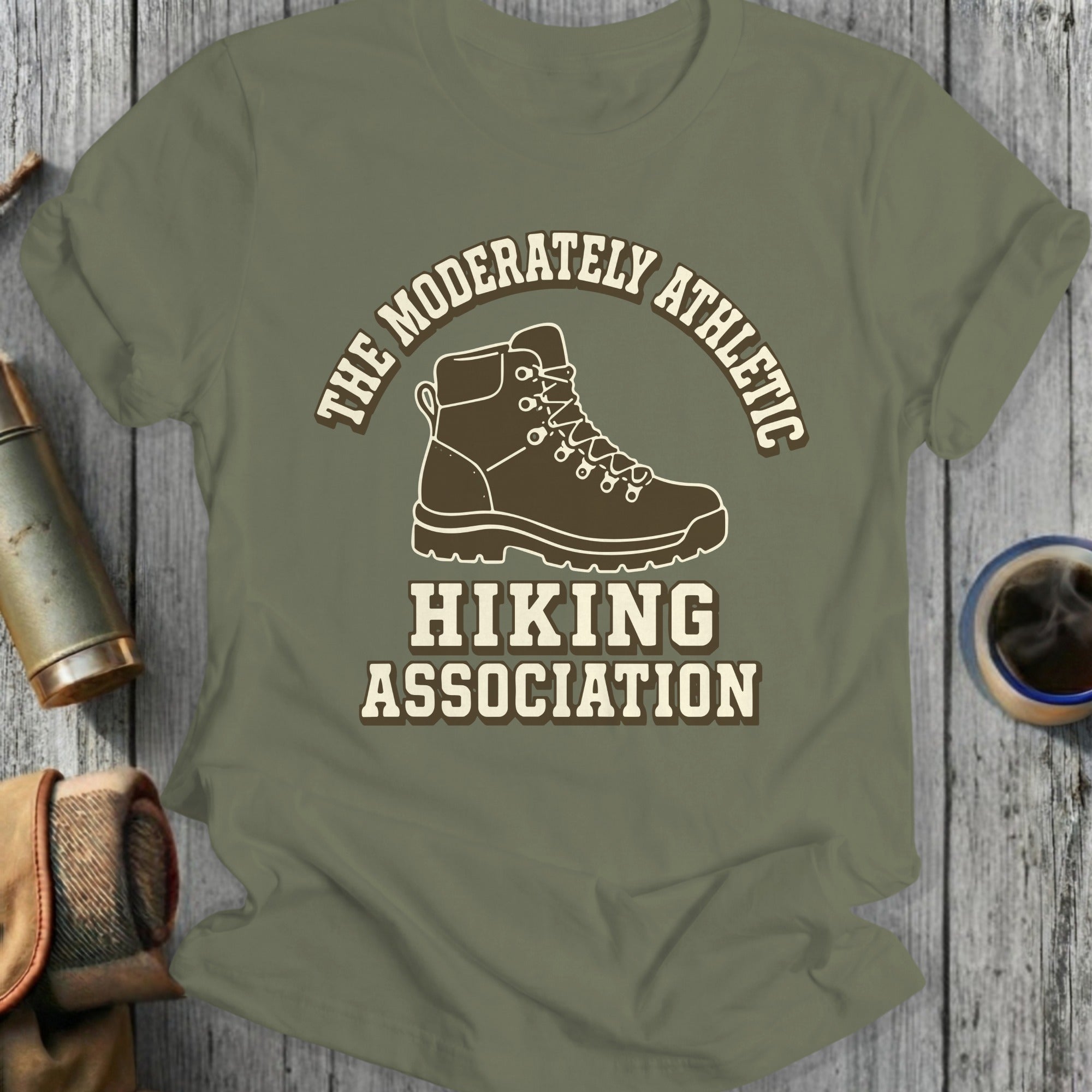 Green t-shirt with "The Moderately Athletic Hiking Association" and hiking boot graphic.