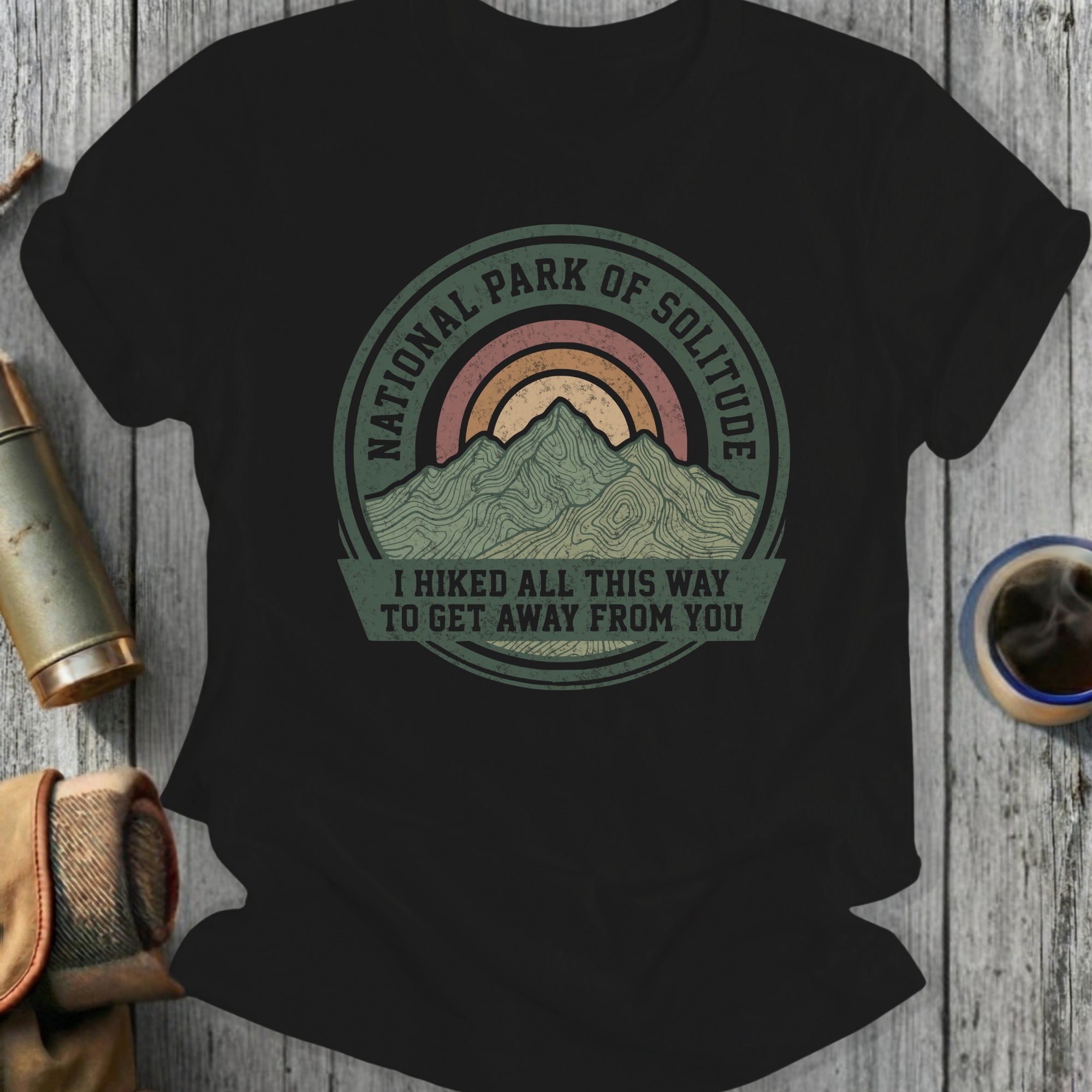 Black t-shirt with "National Park of Solitude" mountain graphic and text.