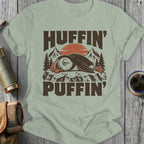 T-shirt graphic: Huffin' Puffin with mountains and sunset.