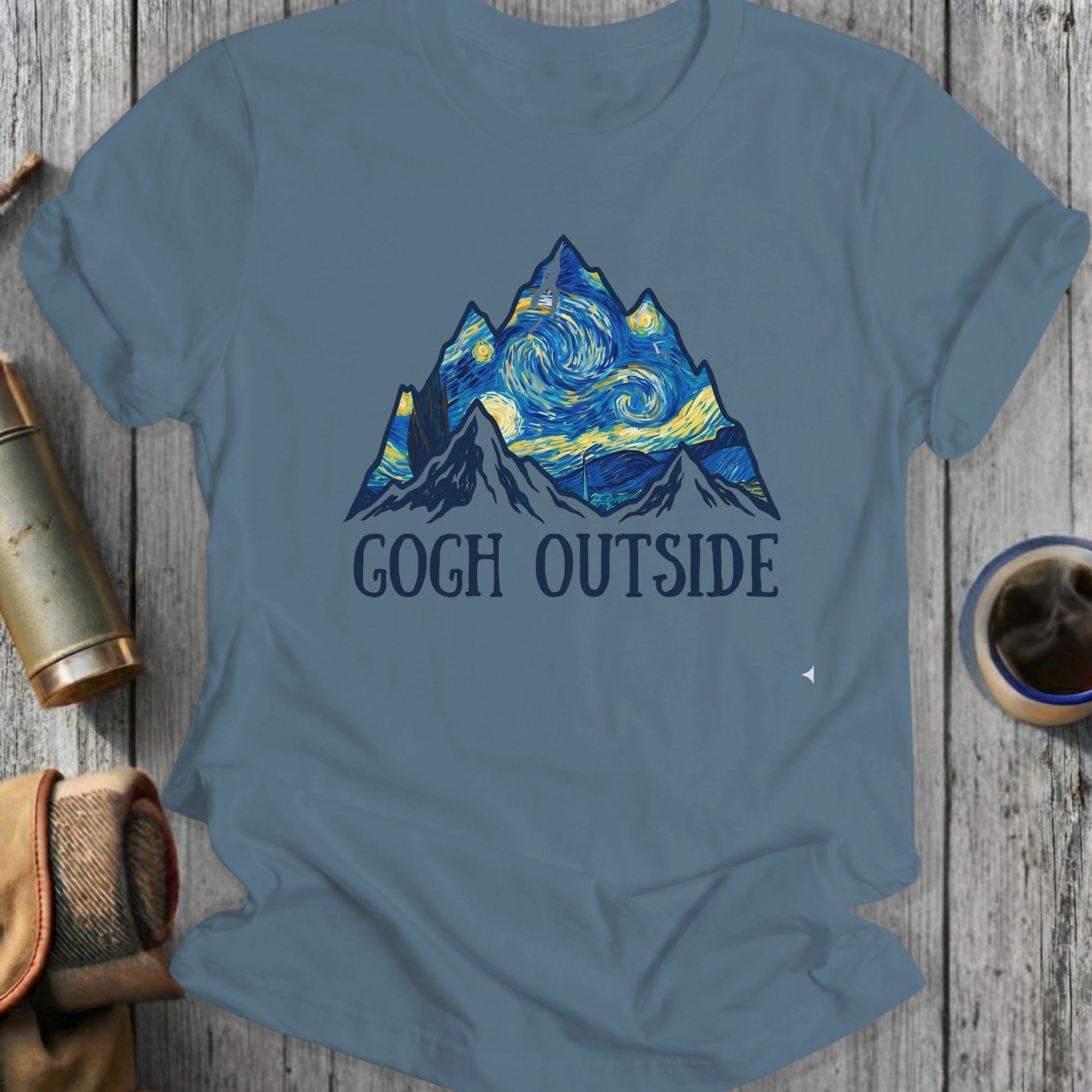"Gogh Outside" text on a t-shirt with a starry night mountain landscape.