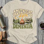 Cream t-shirt with "Adventure Before Dementia" text and camping scene graphic.
