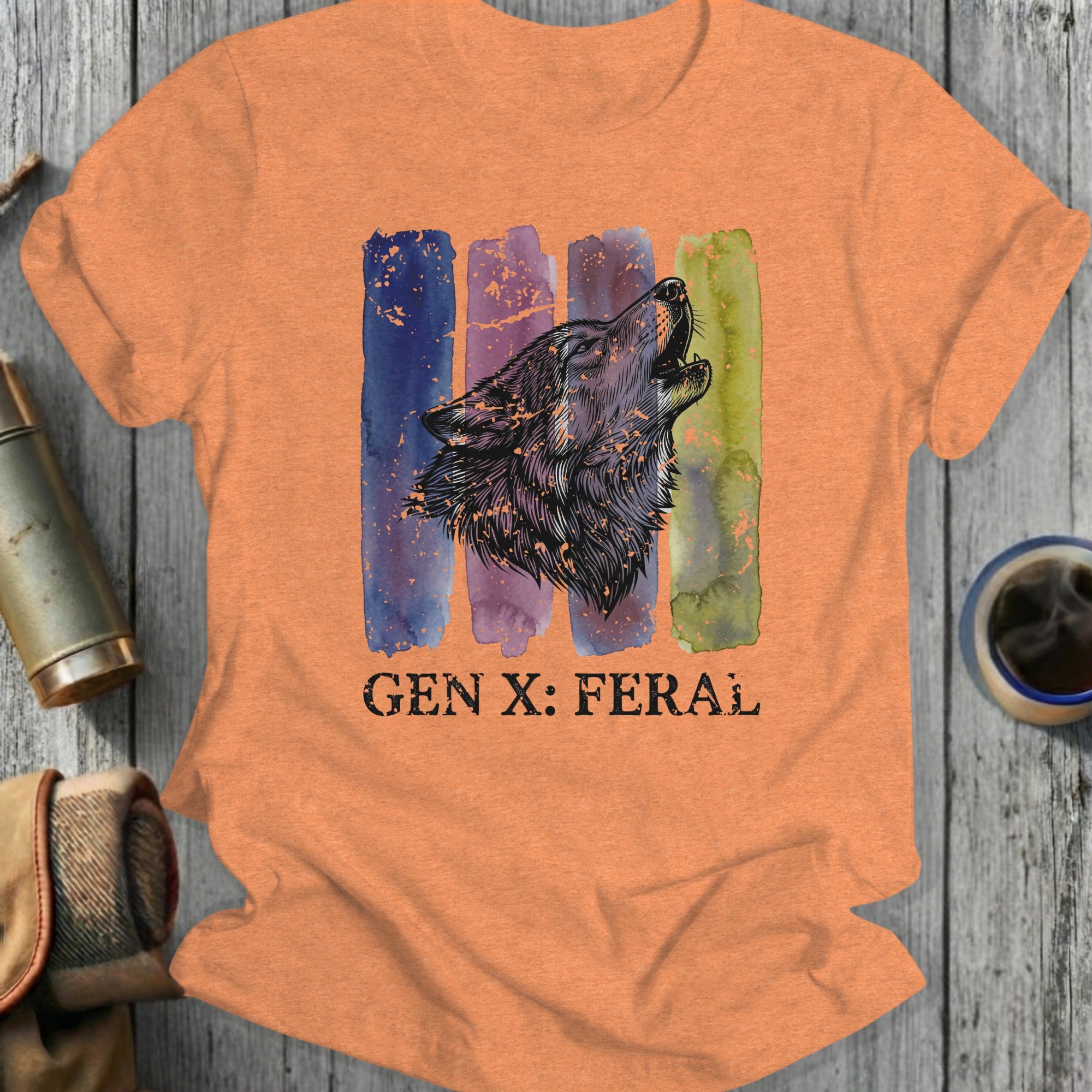 Orange t-shirt with watercolor stripes and howling wolf graphic, text reads "GEN X: FERAL".