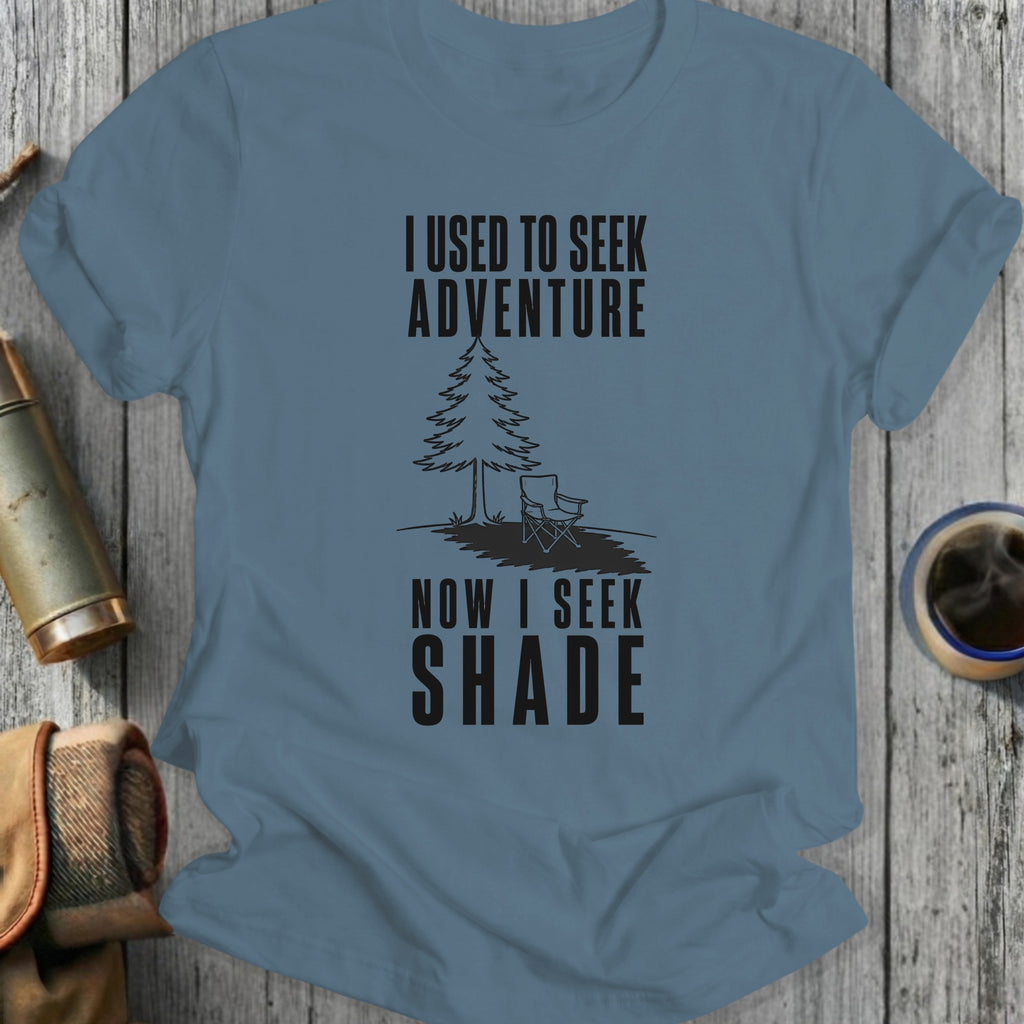 Blue t-shirt with text "I USED TO SEEK ADVENTURE NOW I SEEK SHADE."