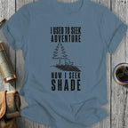 Blue t-shirt with text "I USED TO SEEK ADVENTURE NOW I SEEK SHADE."