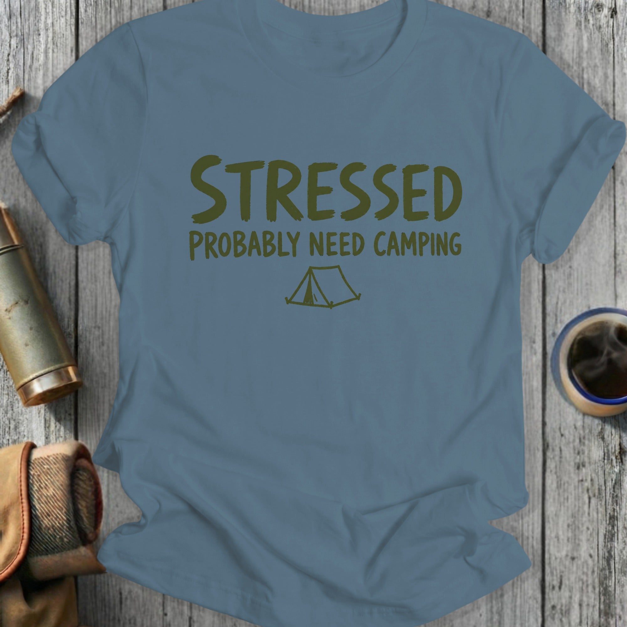 Blue t-shirt with text "STRESSED PROBABLY NEED CAMPING" and a tent graphic.