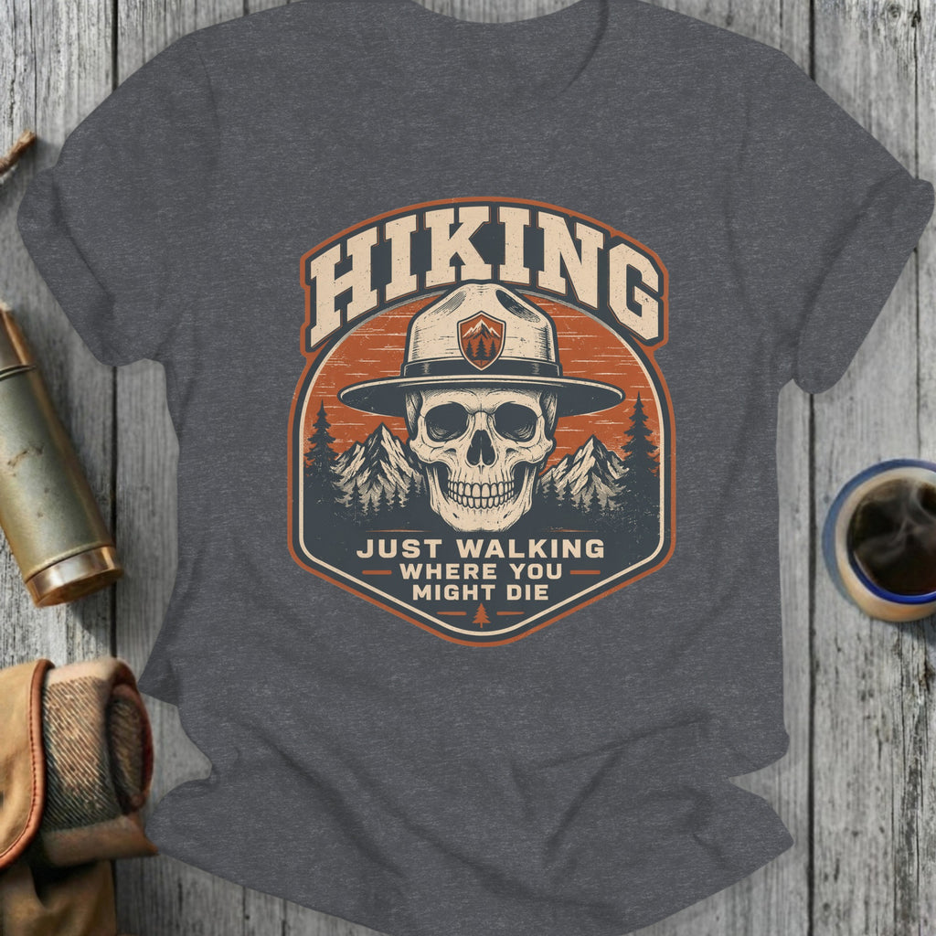 Dark gray t-shirt with a skull wearing a park ranger hat and the text "HIKING JUST WALKING WHERE YOU MIGHT DIE".