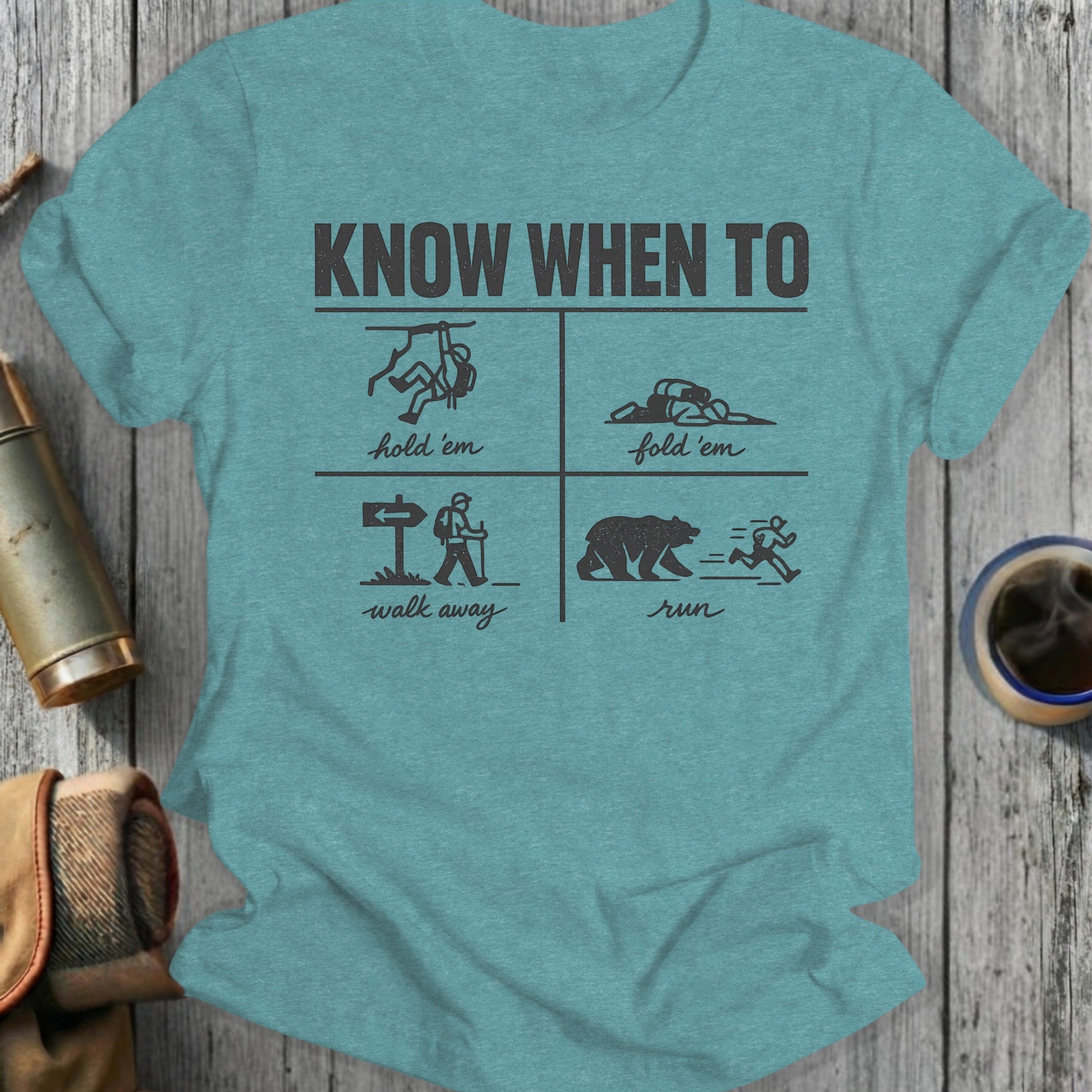 T-shirt graphic: four panels showing "hold 'em" (rock climbing), "fold 'em" (lying down), "walk away" (hiking), and "run" (bear).