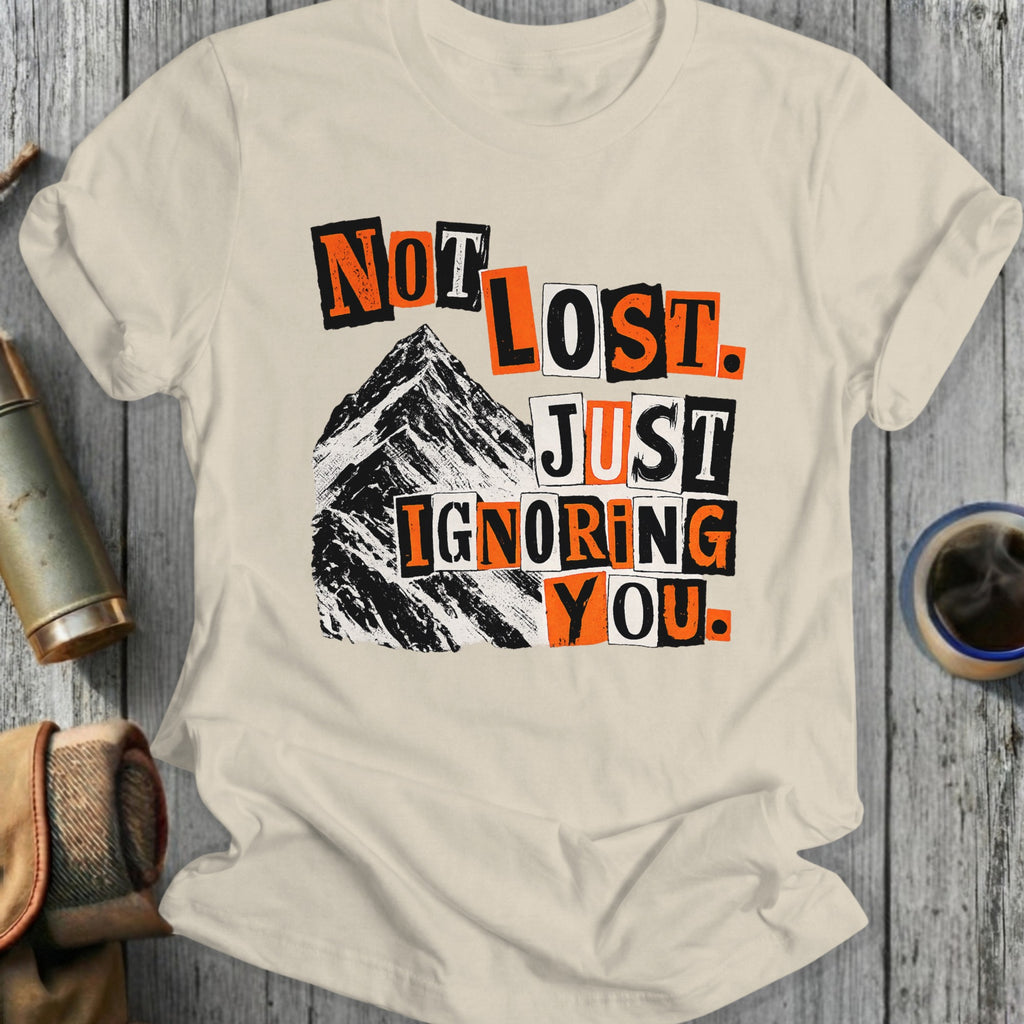 Cream t-shirt with "Not Lost Just Ignoring You" text and mountain graphic.