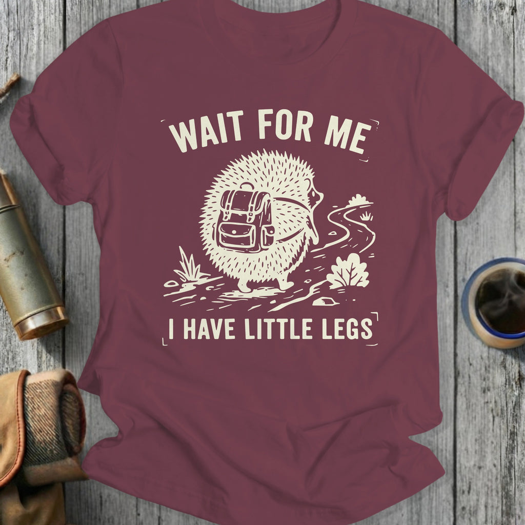 Burgundy t-shirt with hedgehog graphic, backpack, and text "WAIT FOR ME I HAVE LITTLE LEGS".
