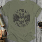 Olive green t-shirt with a circular graphic of a corgi's rear and the text "WAIT FOR ME I HAVE LITTLE LEGS".