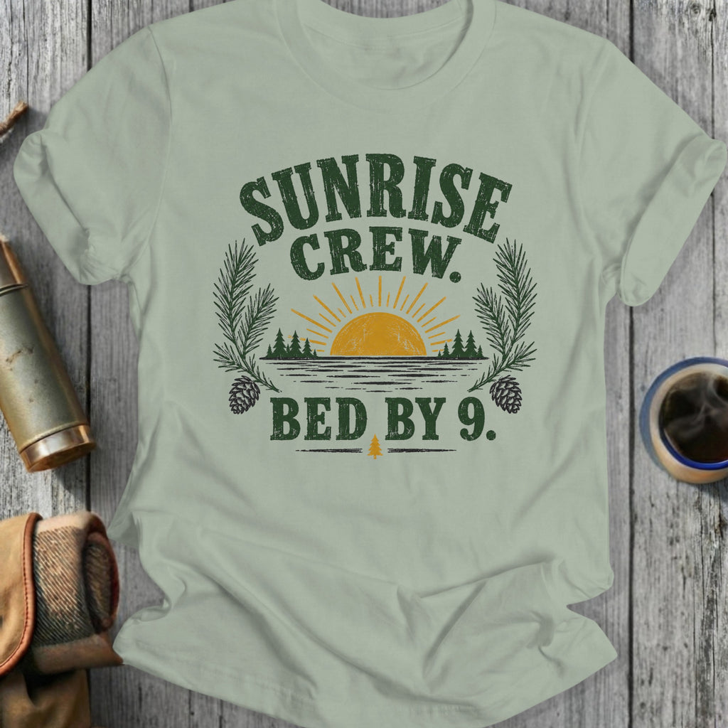Light green t-shirt with "Sunrise Crew. Bed By 9." text and nature graphics.