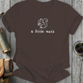 brown t-shirt with white outline of squirrel holding nut and text "a little nuts"