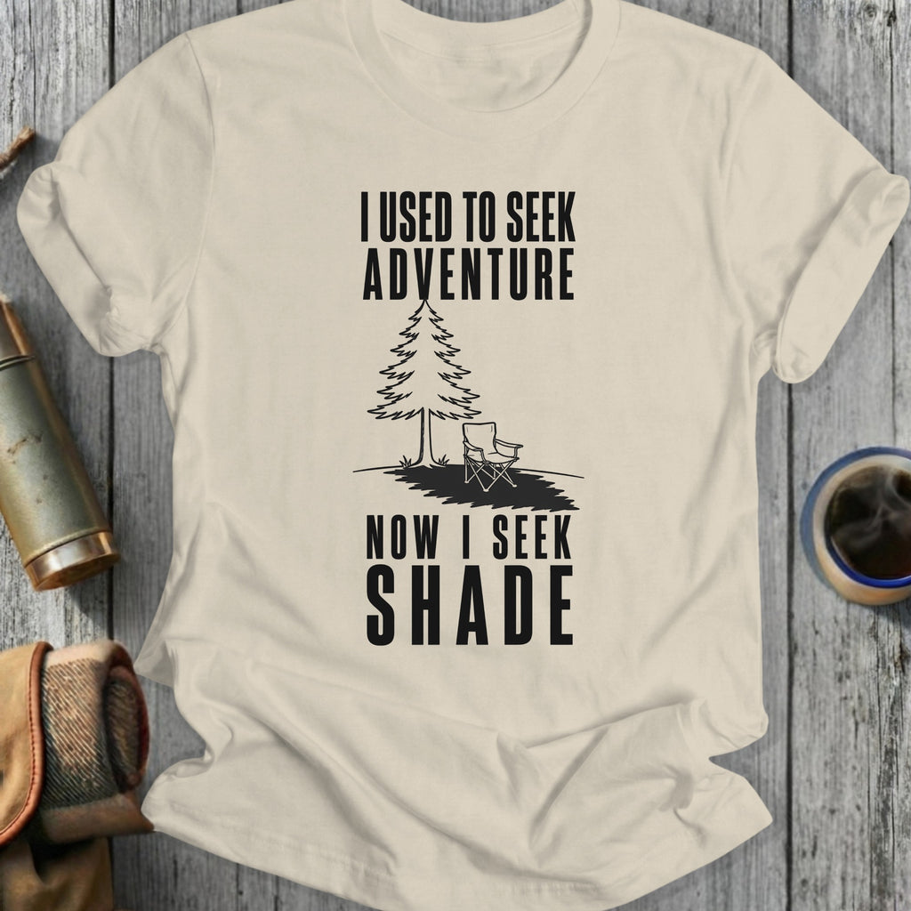 T-shirt with "I used to seek adventure now I seek shade" text and illustration.