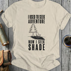 T-shirt with "I used to seek adventure now I seek shade" text and illustration.