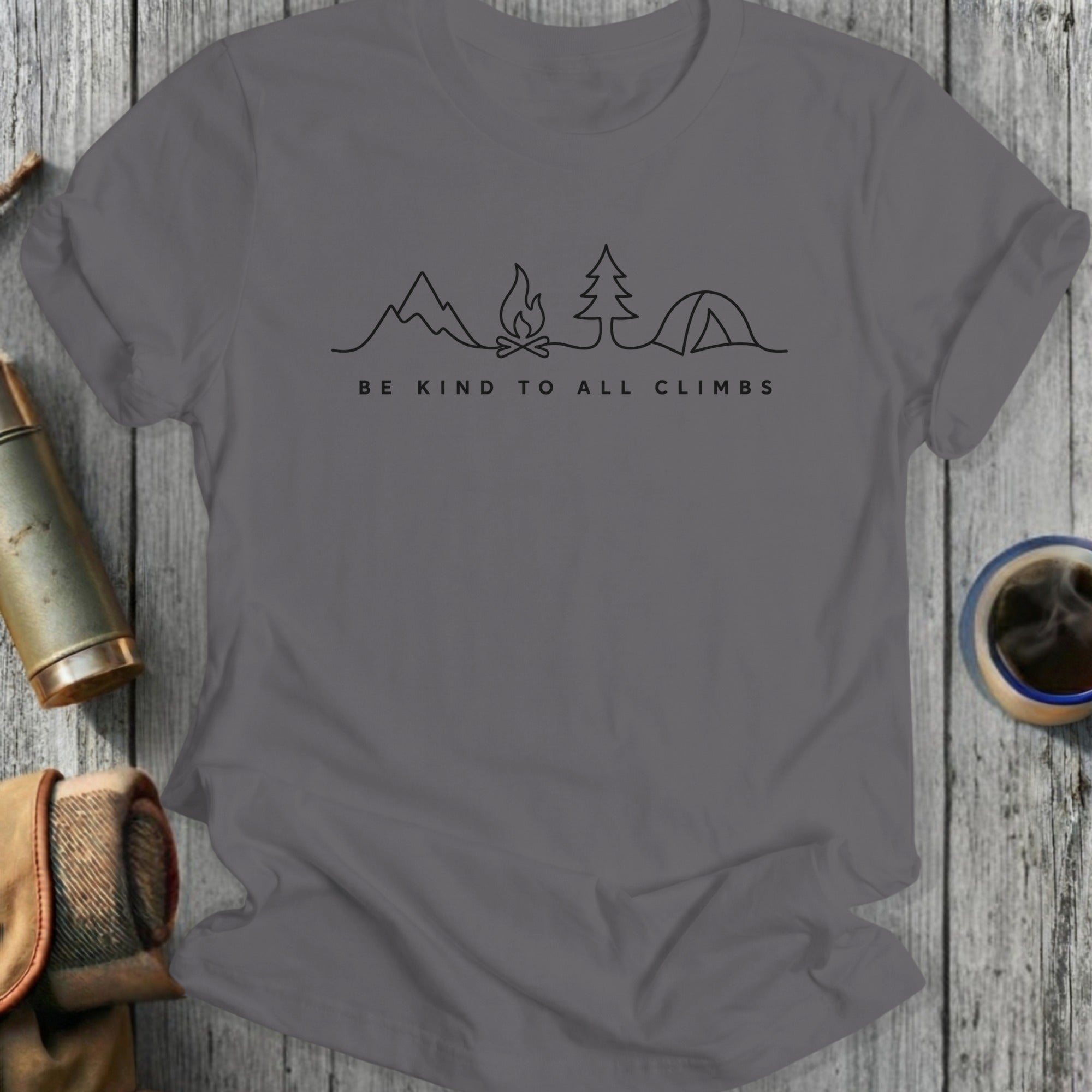 T-shirt with line art of mountains, campfire, tent, and tree; "BE KIND TO ALL CLIMBS".