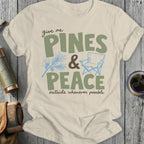 Cream t-shirt with "give me PINES & PEACE outside whenever possible" text.