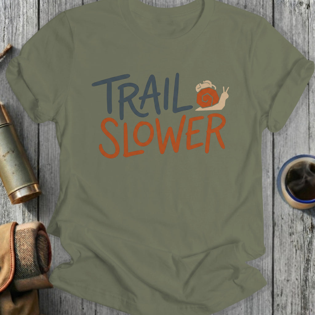 Olive green t-shirt with "TRAIL SLOWER" text and a snail graphic.