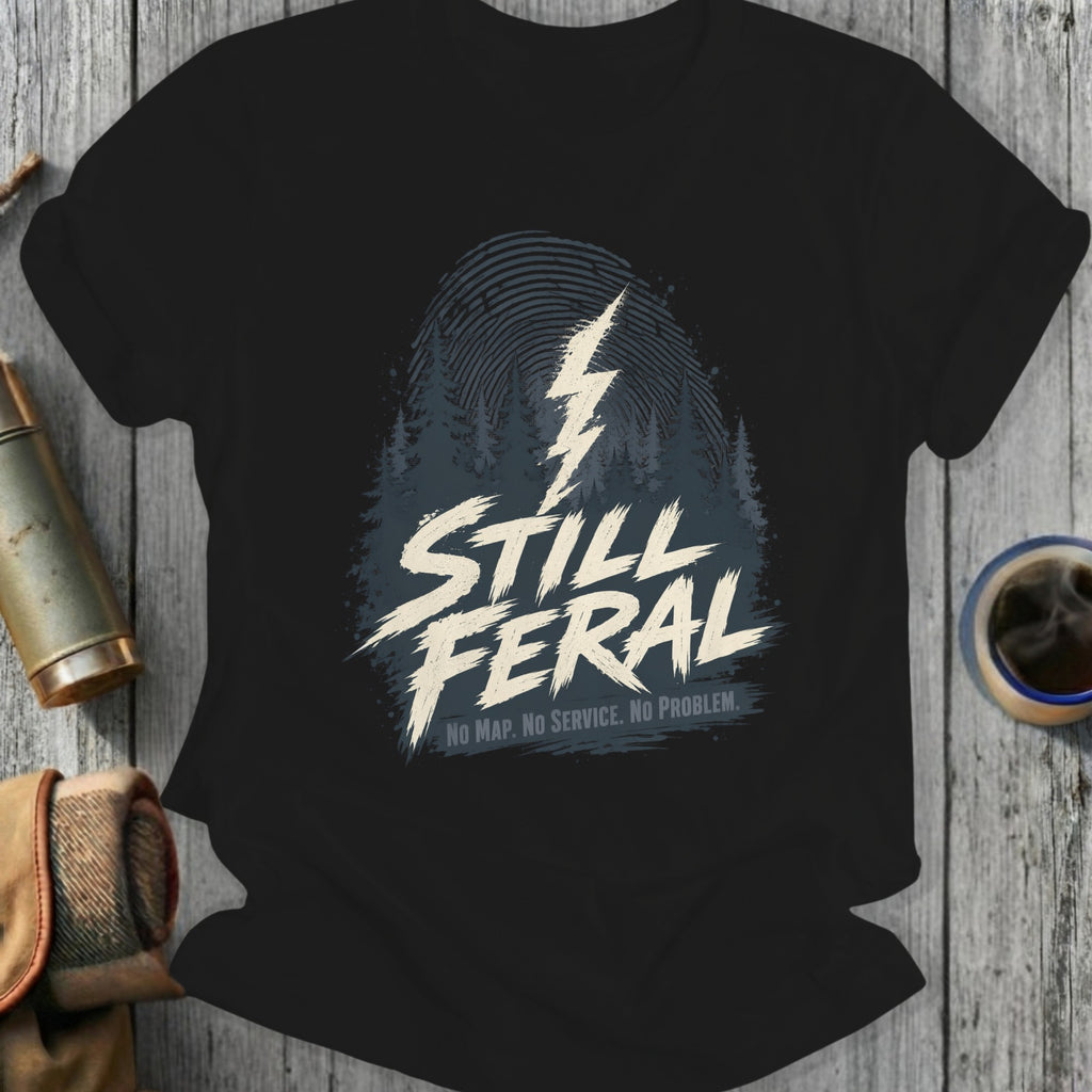 Black t-shirt with "STILL FERAL. NO MAP. NO SERVICE." text and lightning bolt graphic.
