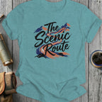 Teal t-shirt with "The Scenic Route" text and mountain graphic.