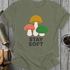 Olive green t-shirt with three colorful mushrooms and the text "STAY SOFT".