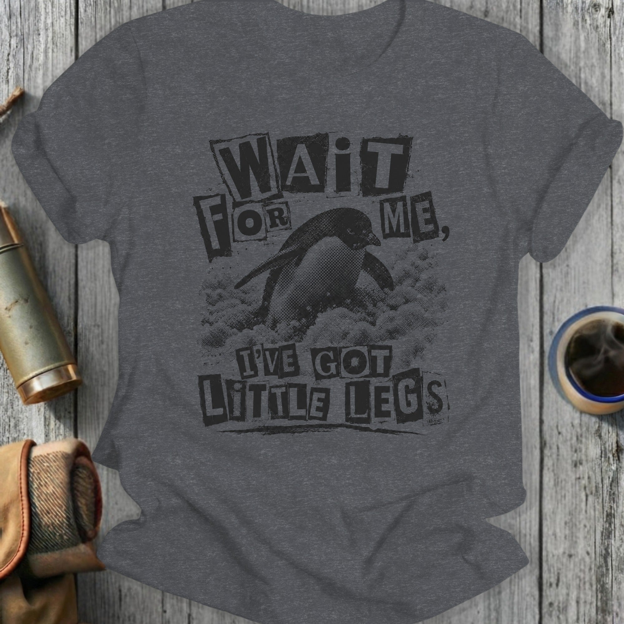Dark grey t-shirt with black text and penguin graphic: "Wait for me, I've got little legs."