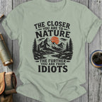 Light green t-shirt with graphic: "The Closer You Are To Nature, The Further You Are From Idiots."