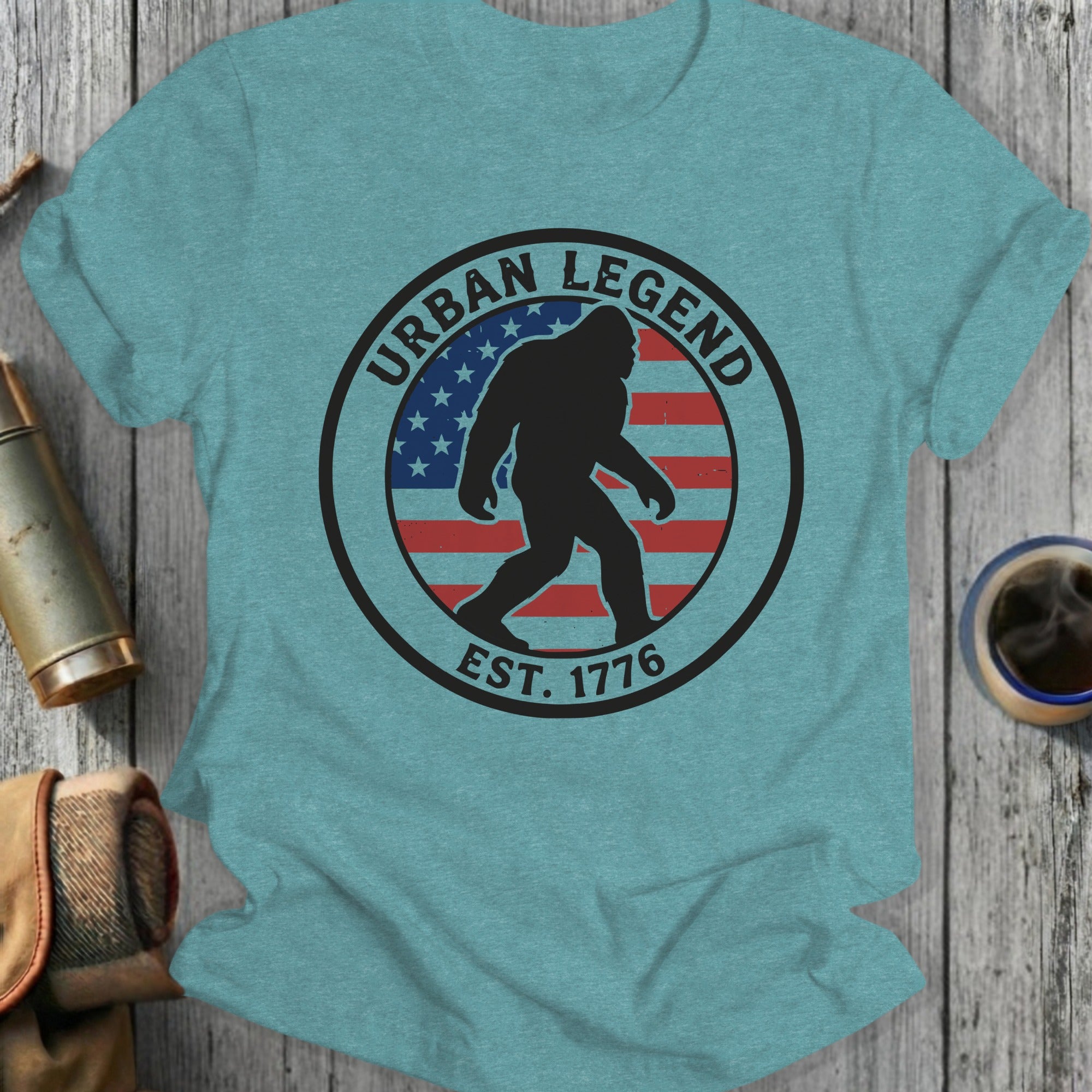 T-shirt with Bigfoot silhouette inside an "Urban Legend Est. 1776" circle and American flag.