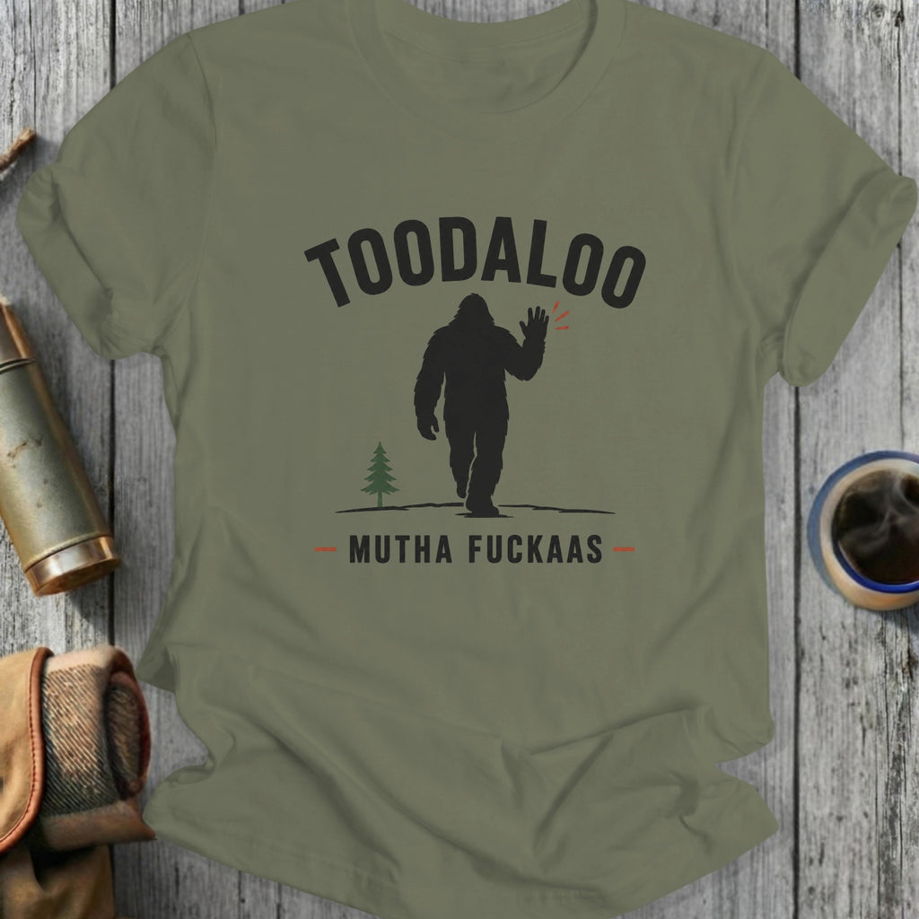 Silhouetted Bigfoot waves goodbye with "TOODALOO MUTHA FUCKAAAS" text.