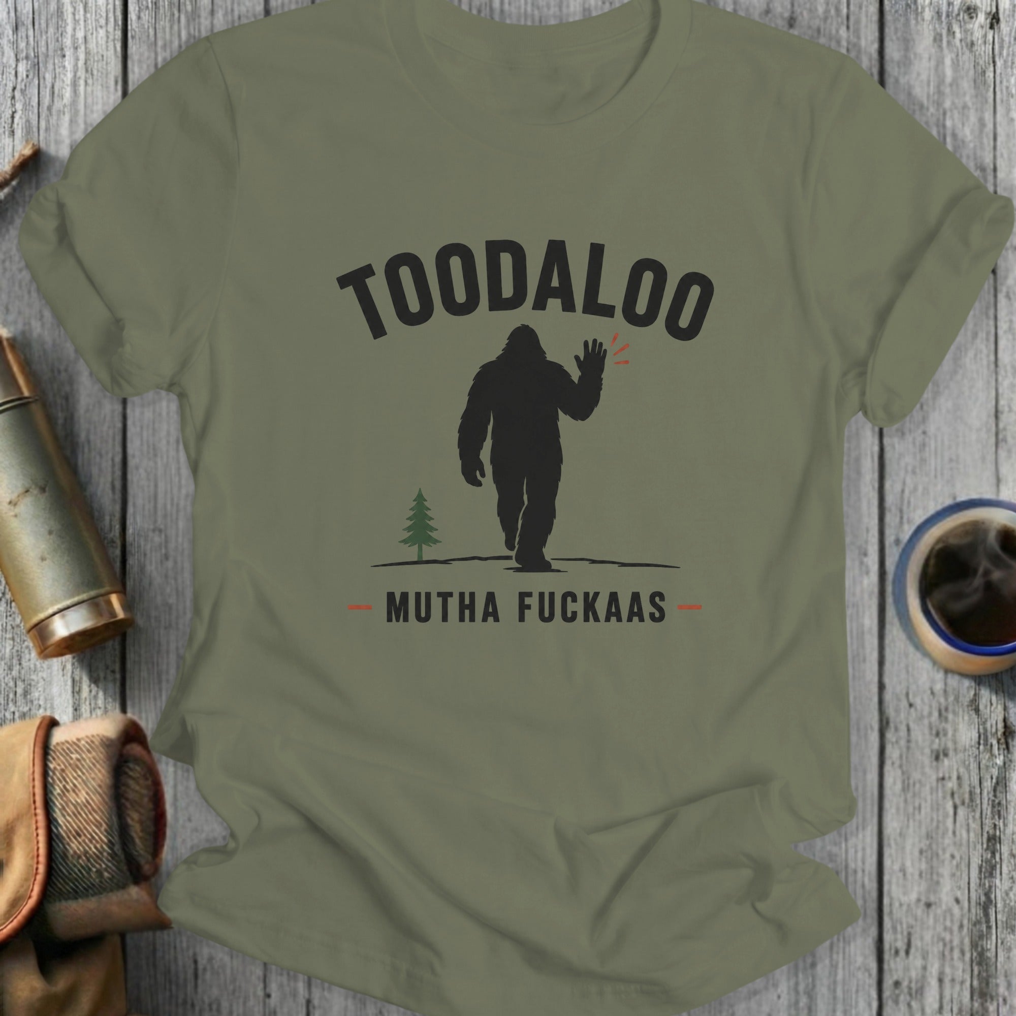 Silhouetted Bigfoot waves goodbye with "TOODALOO MUTHA FUCKAAAS" text.