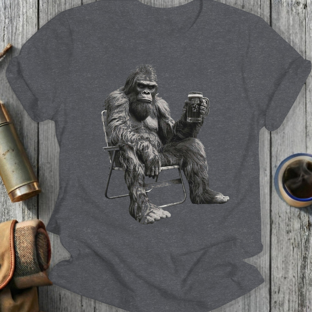 Gorilla sitting in chair holding a beer mug.