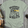T-shirt with graphic: tired owl wearing headlamp, holding watch, "Wilderness Legend In Bed By 9".