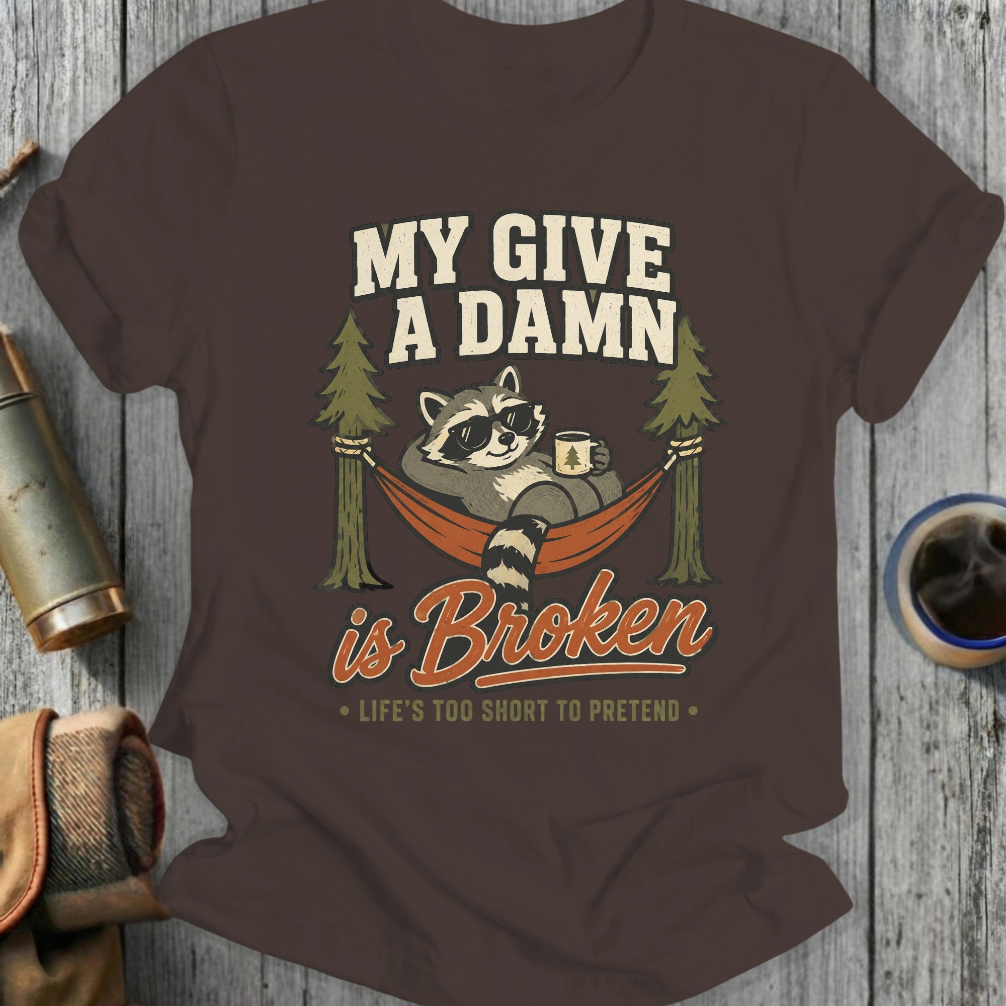 Raccoon in sunglasses relaxing in a hammock with text "My Give A Damn is Broken".