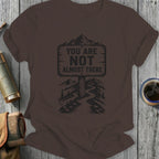 Brown t-shirt with mountain sign reading "YOU ARE NOT ALMOST THERE".
