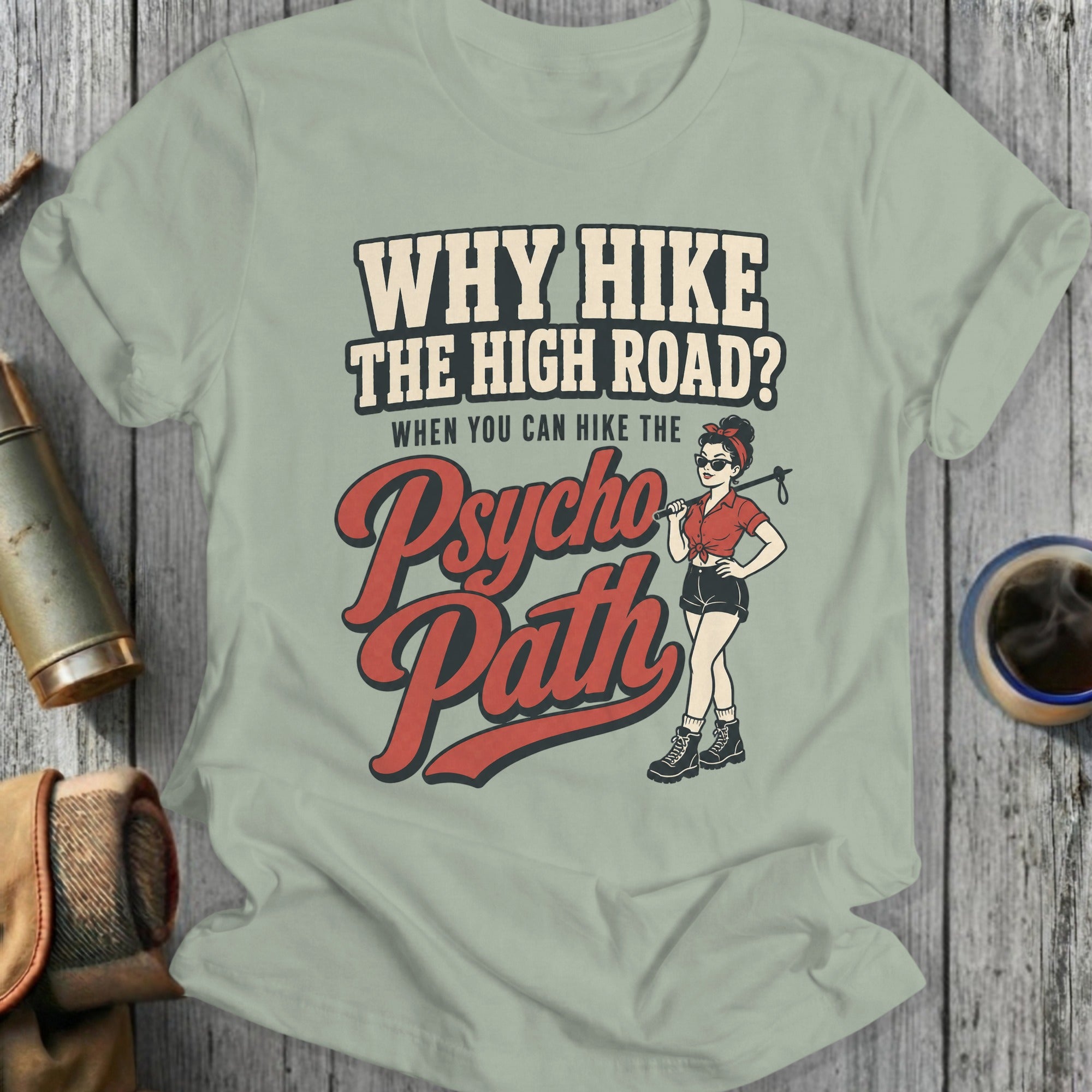 Light green t-shirt with graphic text "Why Hike The High Road? When You Can Hike The Psycho Path" and illustration.