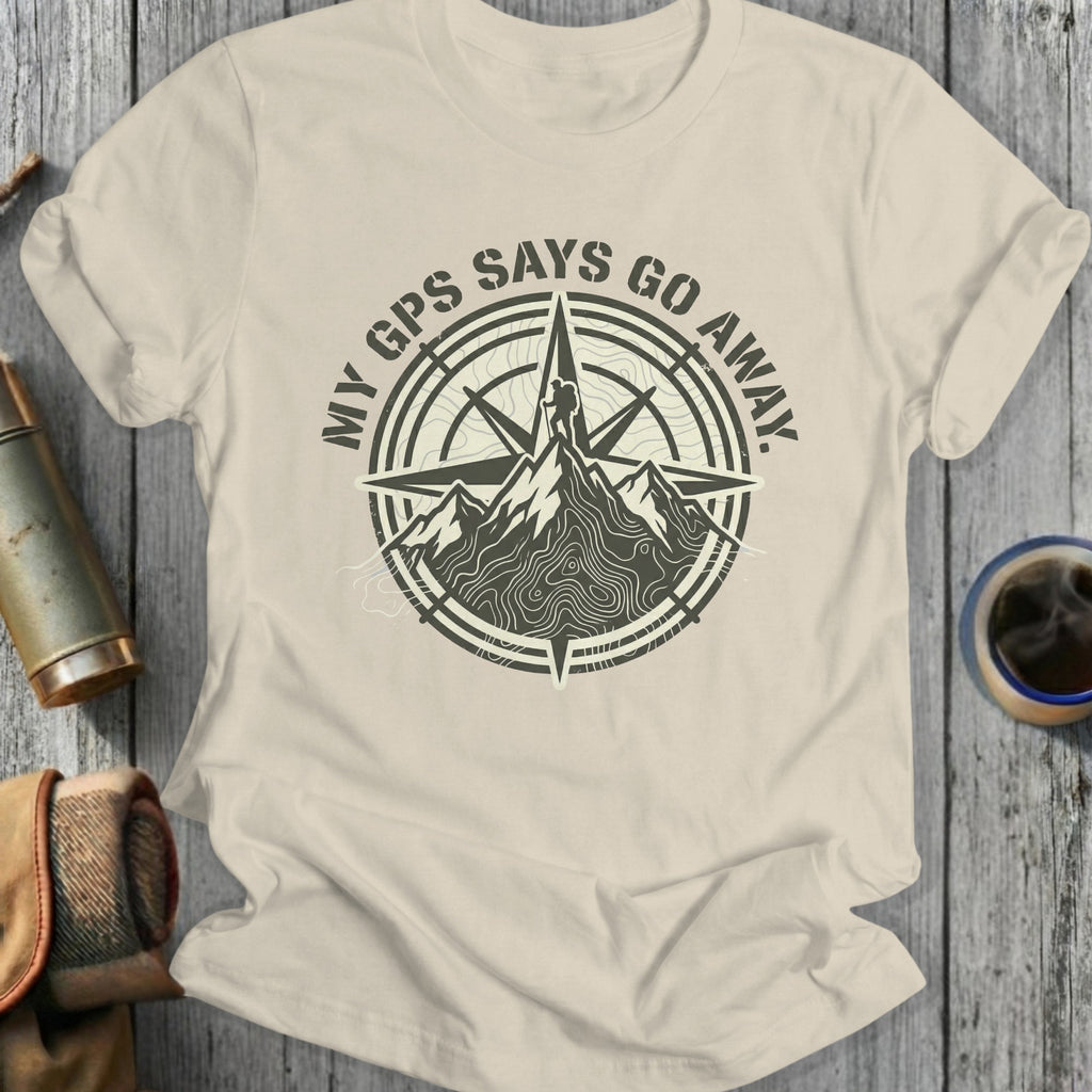 Cream t-shirt with a compass and mountain graphic, text "MY GPS SAYS GO AWAY."