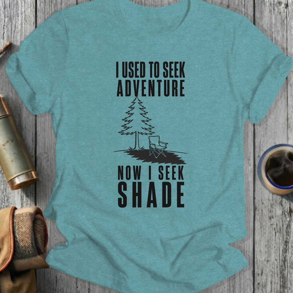 T-shirt with text "I Used to Seek Adventure, Now I Seek Shade" and tree graphic.
