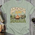 Adventure before Dementia graphic with camper, tent, and campfire on light green shirt.