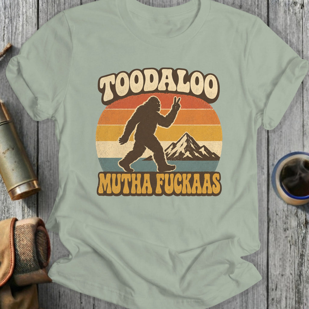 Bigfoot giving peace sign with "TOODALOO MUTHA FUCKAAS" text on vintage sunset design.