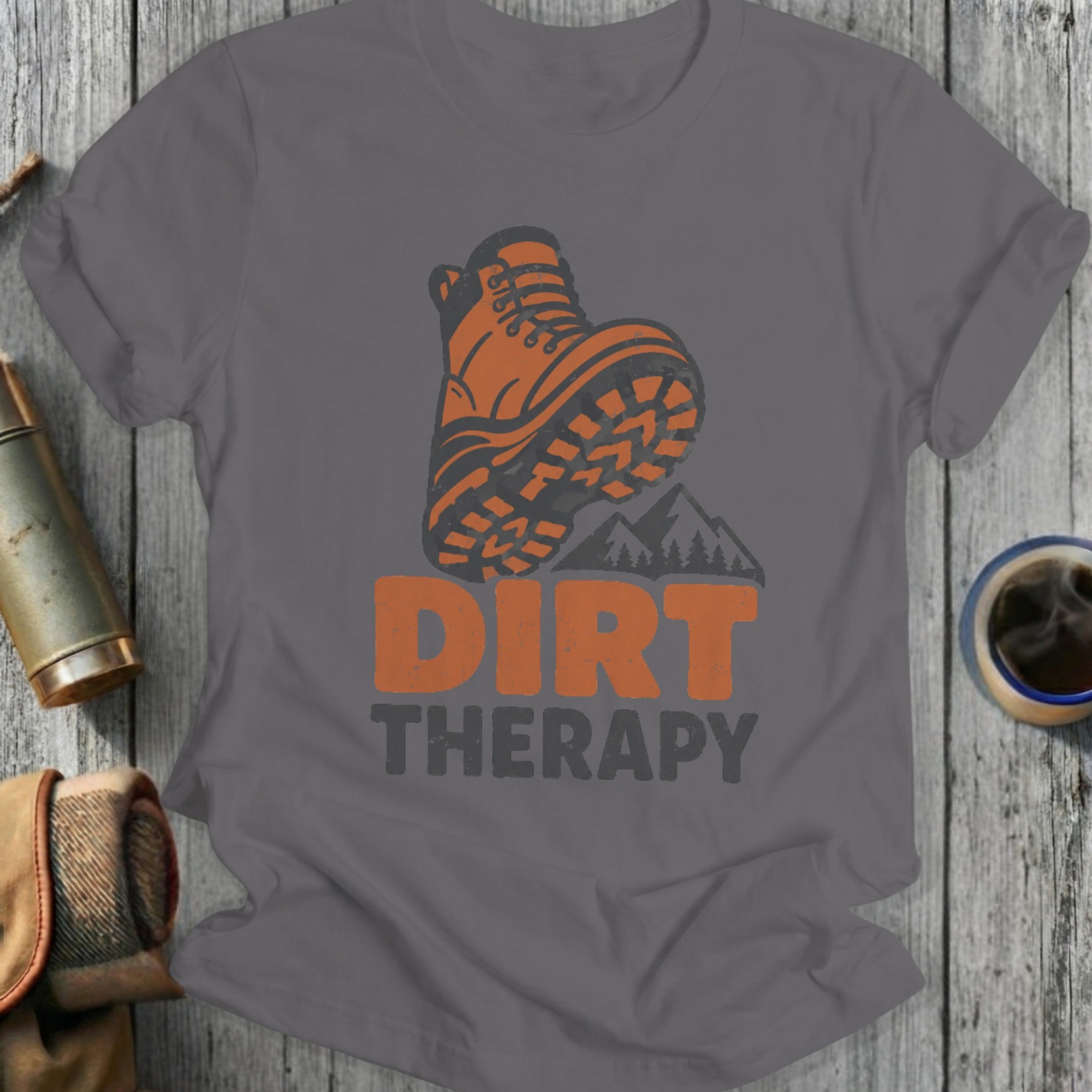 Orange hiking boot graphic with "DIRT THERAPY" text on a gray t-shirt.