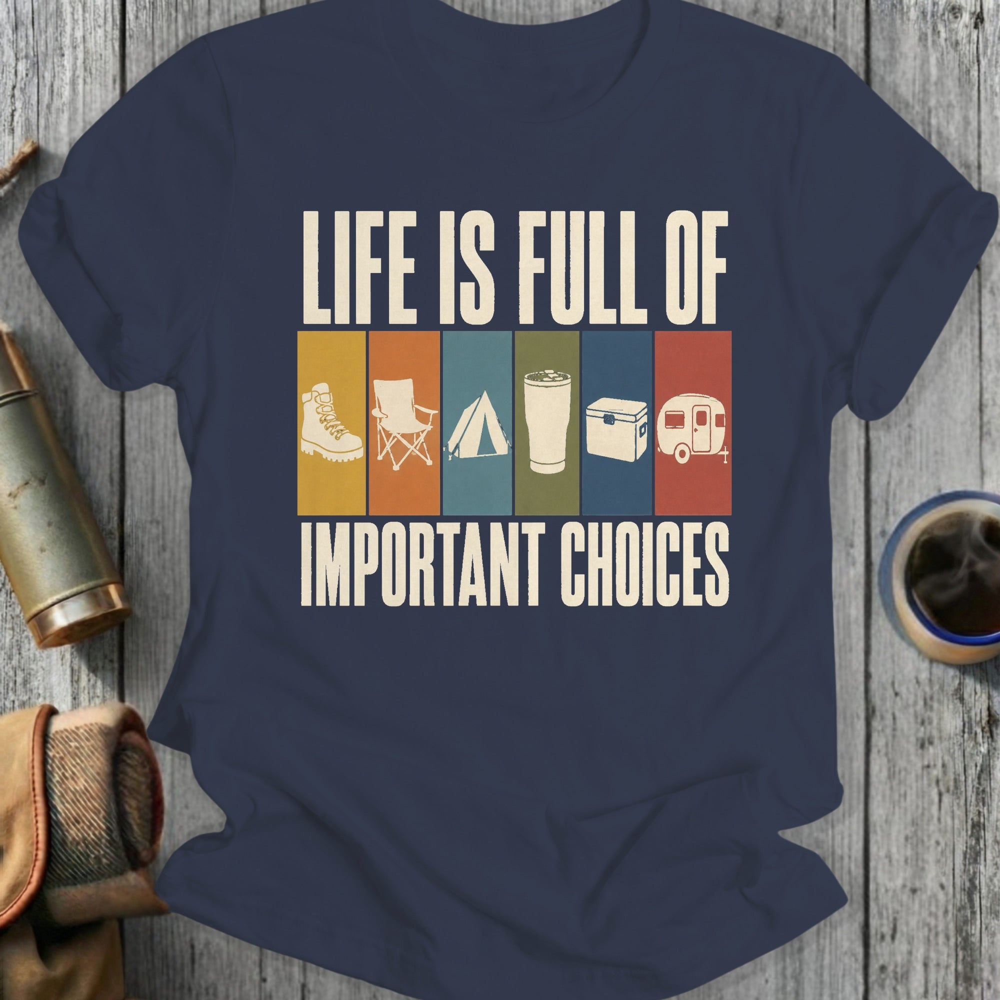 Dark blue t-shirt with "Life is full of important choices" over camping icons.