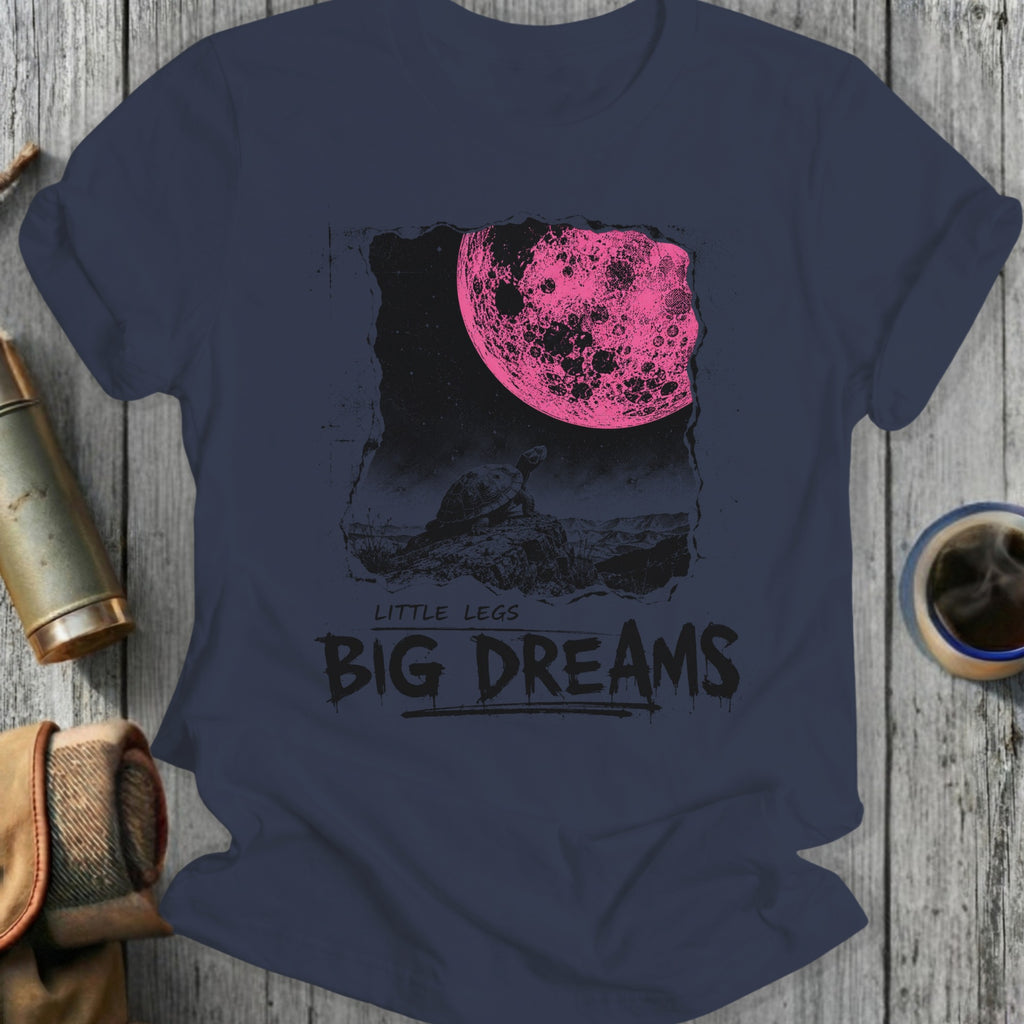 Dark t-shirt with graphic of tortoise looking at a large pink moon with "BIG DREAMS" text.
